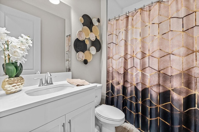 bathroom with toilet, vanity, and a shower with shower curtain