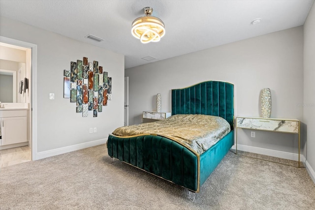 bedroom featuring carpet and connected bathroom