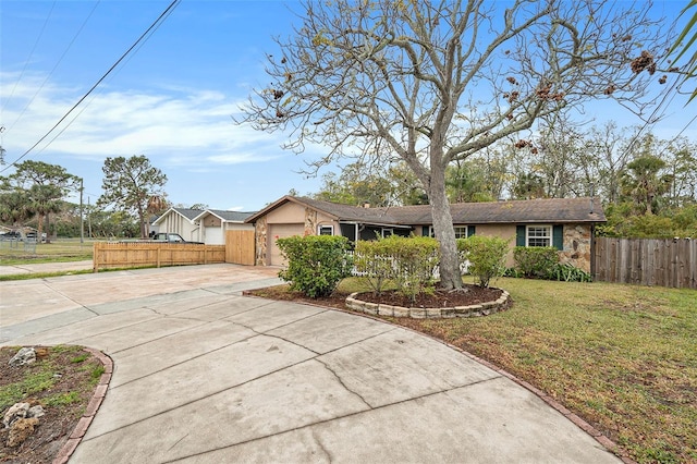 ranch-style house featuring a front yard and a garage