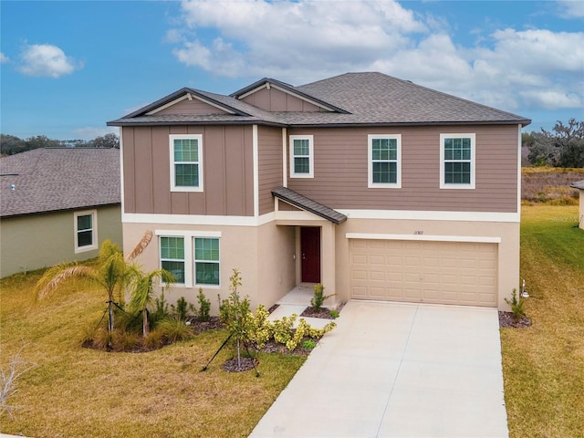 view of front of property featuring a garage and a front yard