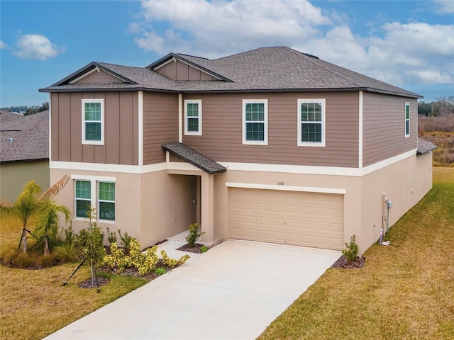 view of front of home featuring a front lawn and a garage