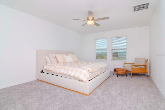 bedroom with ceiling fan and light colored carpet