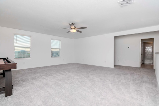 carpeted empty room featuring ceiling fan