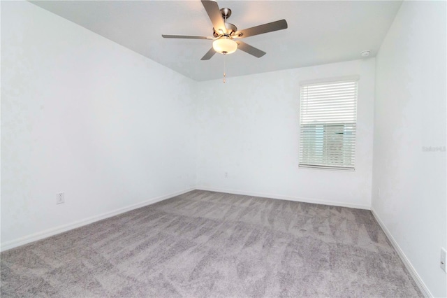 spare room with light carpet and ceiling fan