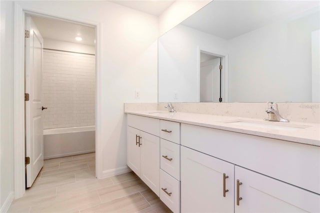 bathroom featuring vanity and tiled shower / bath