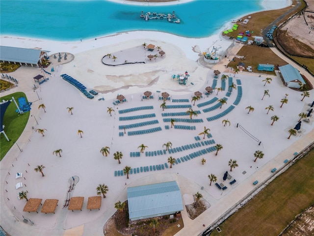 bird's eye view featuring a water view and a beach view