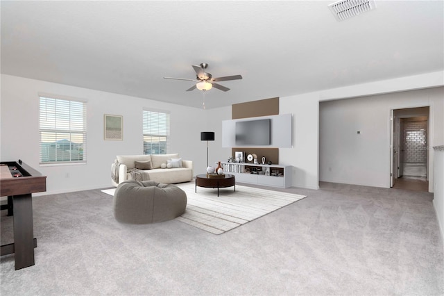 living room featuring light carpet and ceiling fan