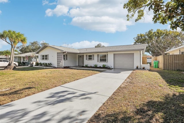 ranch-style house featuring a front yard and a garage