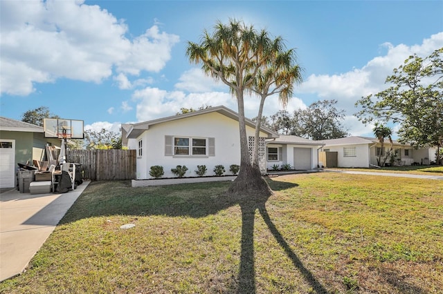 view of front facade with a garage and a front lawn