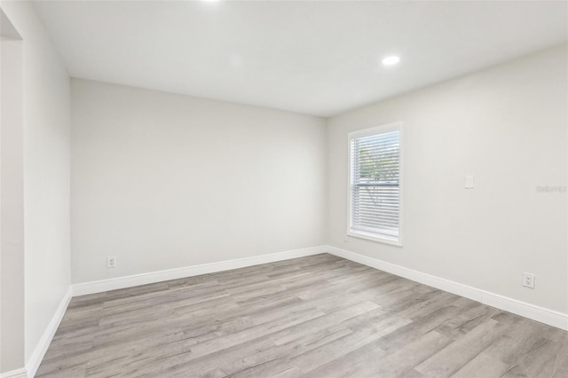 spare room with light hardwood / wood-style flooring