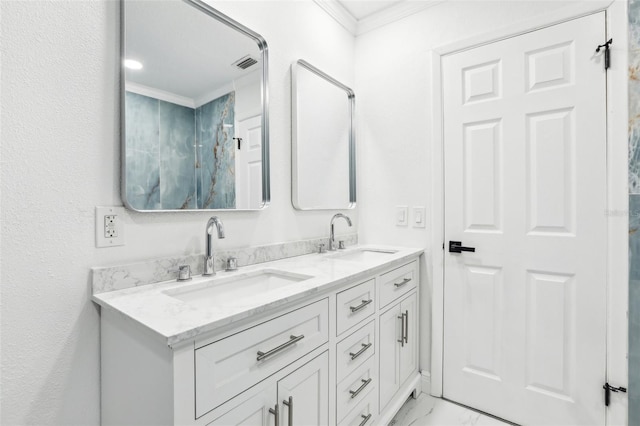 bathroom with crown molding and vanity