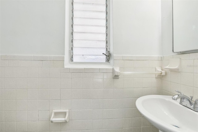 bathroom with tile walls and sink