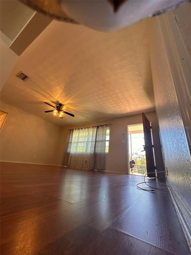 unfurnished living room featuring ceiling fan