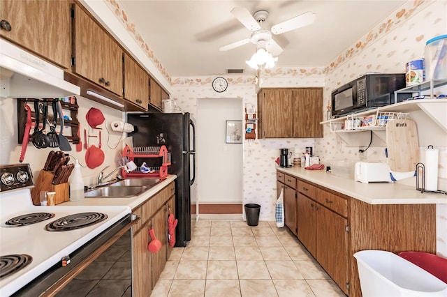 kitchen featuring black appliances, ceiling fan, light tile patterned floors, and sink