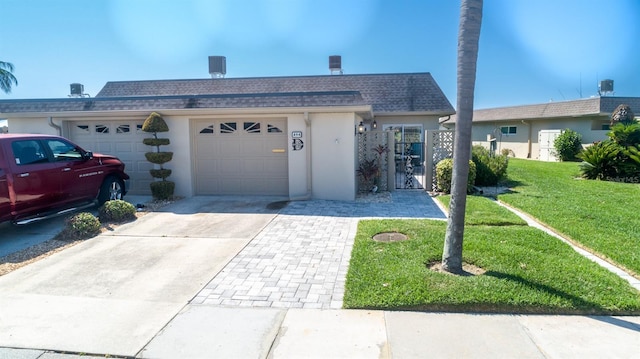 ranch-style house featuring a garage and a front yard