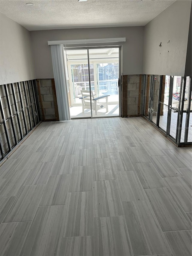 unfurnished room with a textured ceiling