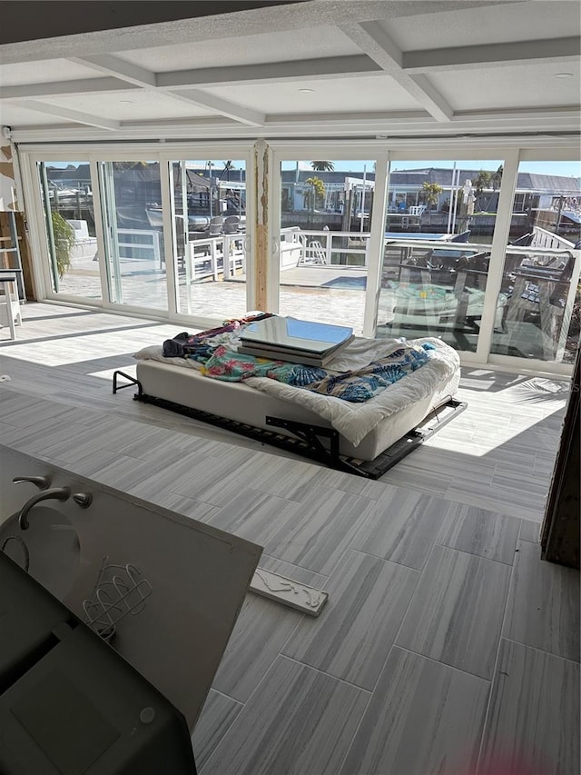 living room featuring beamed ceiling and coffered ceiling