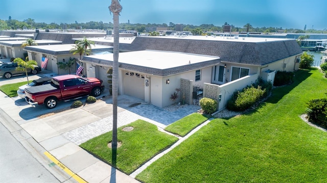 view of front of property with a front yard and a garage