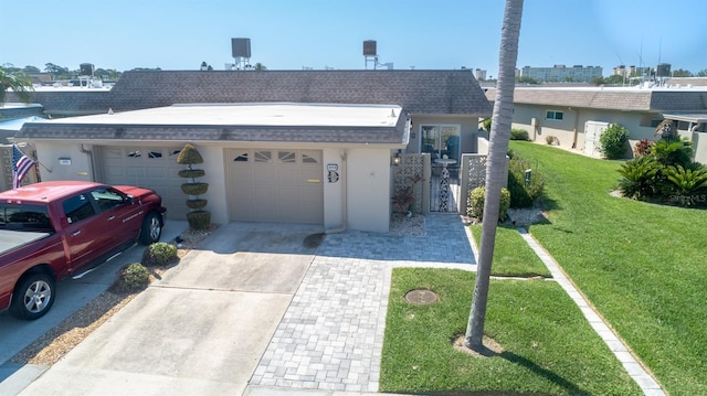 single story home featuring a front lawn and a garage