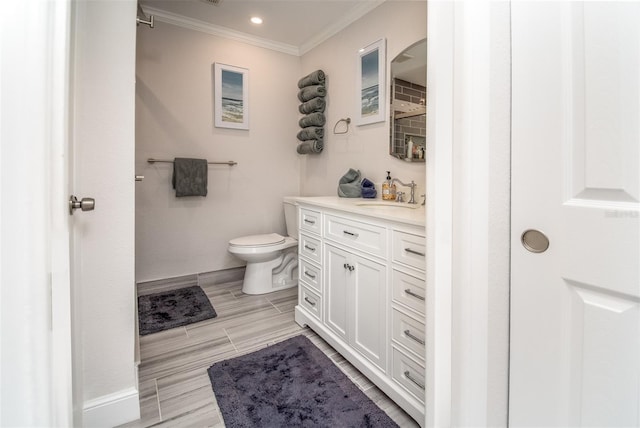 bathroom featuring ornamental molding, vanity, and toilet