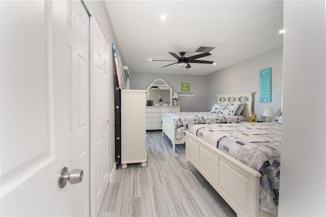 bedroom with ceiling fan and a closet