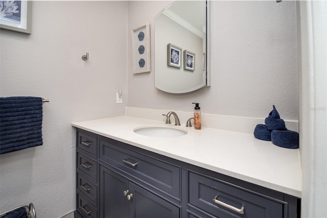 bathroom with ornamental molding and vanity