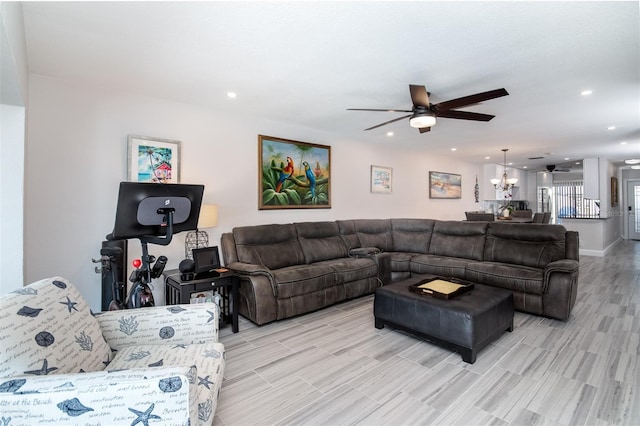 living room with ceiling fan with notable chandelier