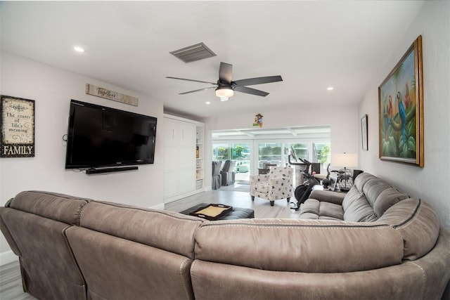 living room with ceiling fan and light hardwood / wood-style flooring