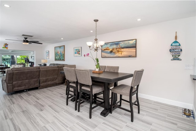 dining room with ceiling fan with notable chandelier