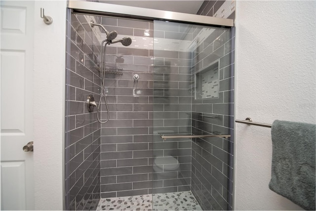 bathroom with a shower with shower door