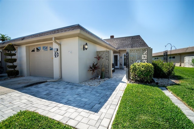 view of front facade with a front lawn and a garage