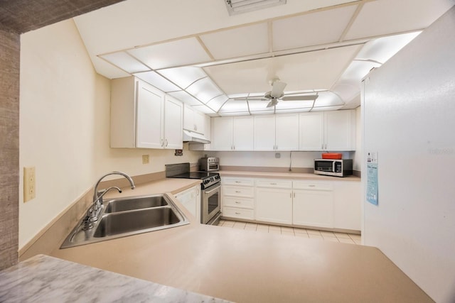 kitchen with appliances with stainless steel finishes, sink, white cabinets, and kitchen peninsula