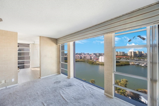 unfurnished sunroom with a water view