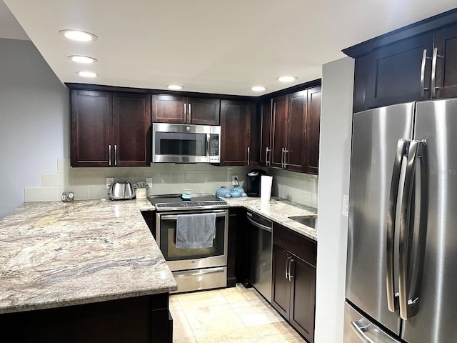 kitchen featuring appliances with stainless steel finishes, light stone countertops, dark brown cabinets, and light tile patterned floors