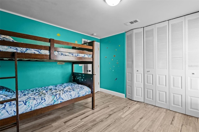 bedroom featuring a closet and light hardwood / wood-style flooring