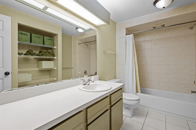 full bathroom with vanity, a textured ceiling, shower / bath combo with shower curtain, tile patterned flooring, and toilet