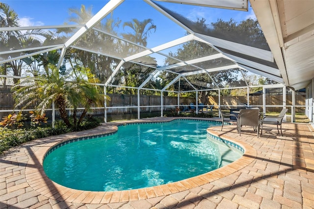 view of pool featuring a patio and glass enclosure