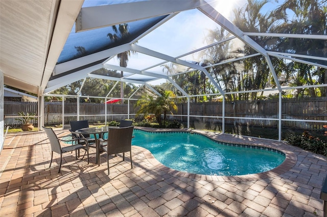 view of swimming pool with a lanai and a patio