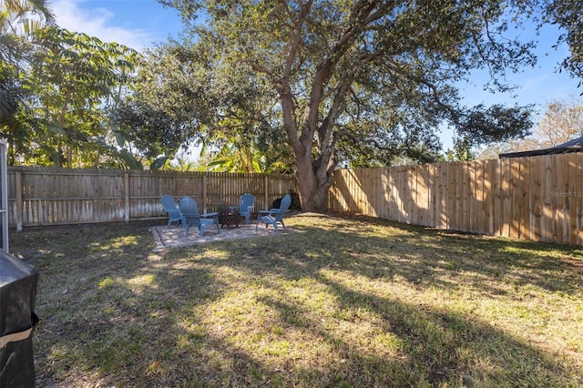 view of yard with an outdoor fire pit and a patio area