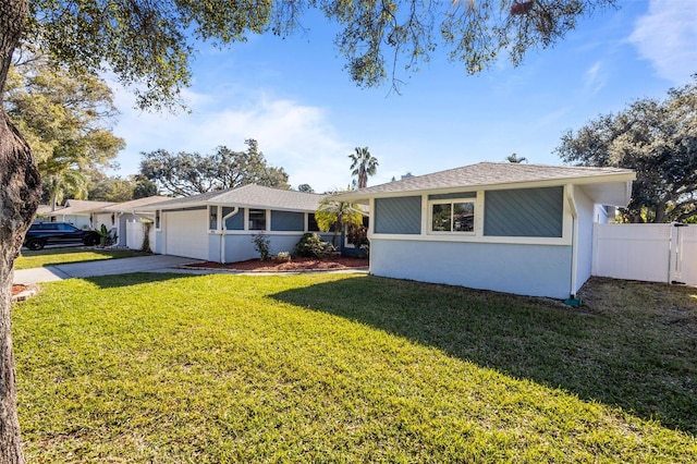 ranch-style home featuring a garage and a front lawn