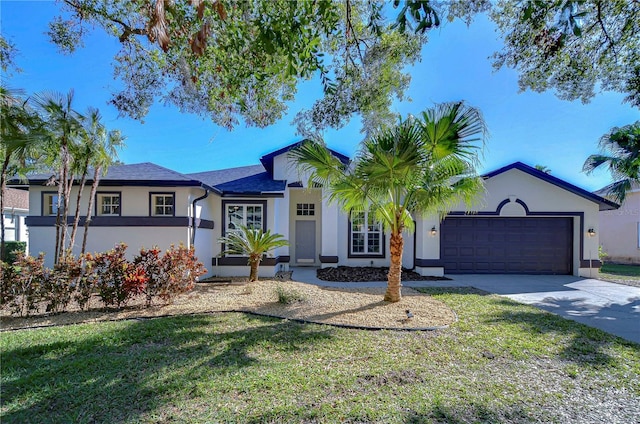 ranch-style home featuring a front yard and a garage