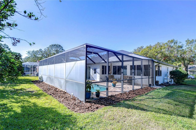 exterior space featuring a yard, a patio, and a lanai