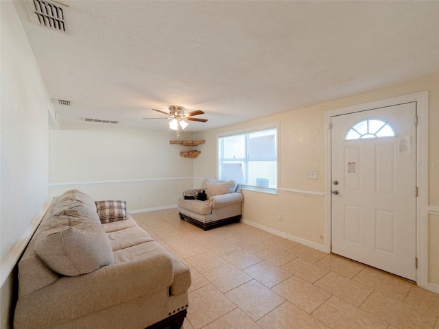 tiled living room featuring ceiling fan and a healthy amount of sunlight