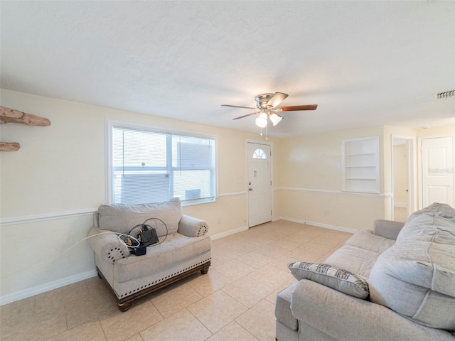 tiled living room featuring ceiling fan