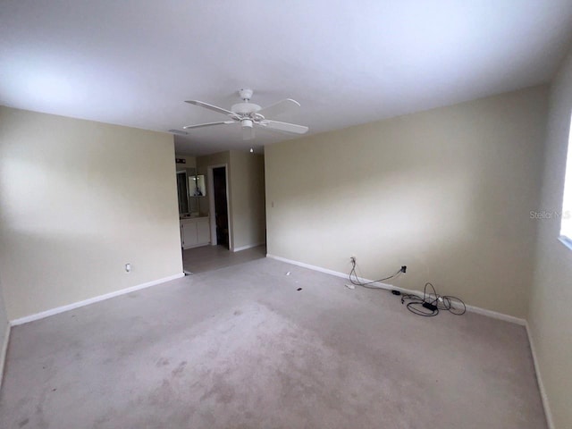 carpeted spare room with ceiling fan