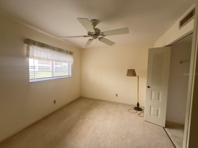 carpeted empty room with ceiling fan