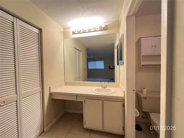 bathroom with vanity, toilet, and tile patterned floors