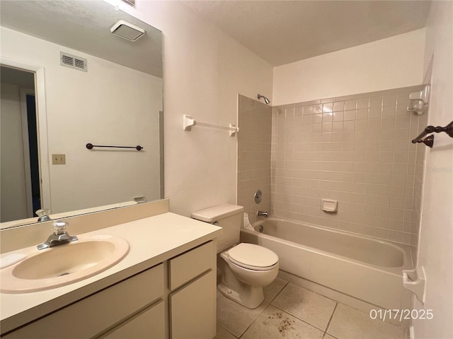 full bathroom featuring tile patterned floors, toilet, vanity, and tiled shower / bath