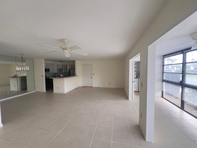 unfurnished living room with ceiling fan and light tile patterned floors