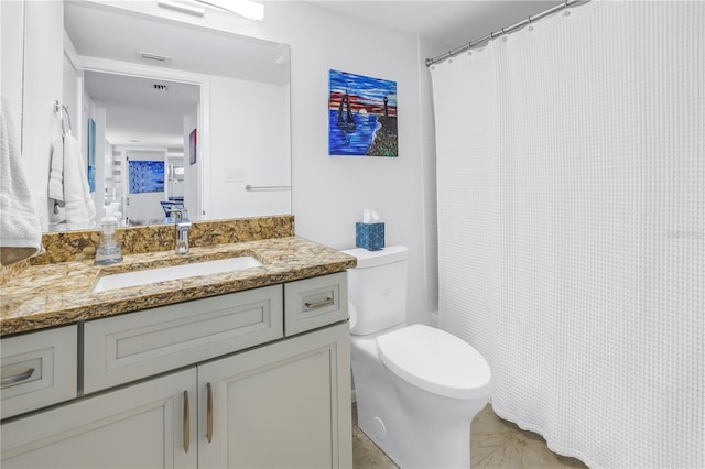 bathroom with toilet and vanity